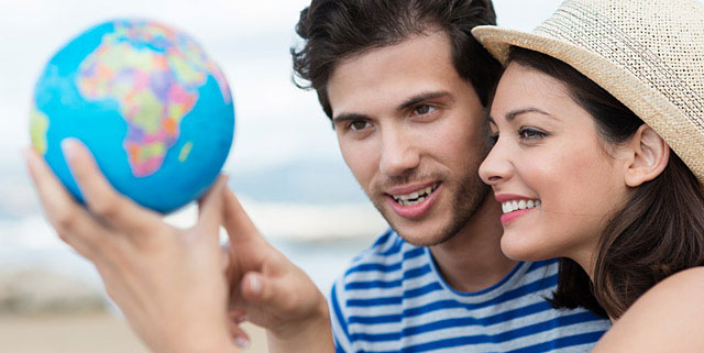 Man and woman looking at a globe